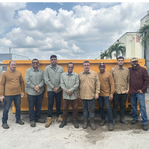 The Dumpsters Back to Life team gathered in front of a roll-off dumpster, showcasing their dedication and expertise.